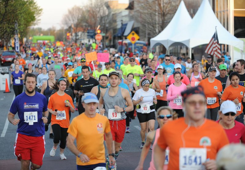 NWA Democrat-Gazette/ANDY SHUPE Runners depart Saturday at the start line on Emma Avenue during the 41st annual Hogeye Marathon, Half-Marathon, 5K and Relays in downtown Springdale. This is the first year for the race to be held in Springdale after it was moved from its original location in Fayetteville.