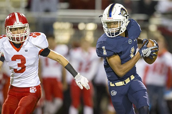 Bentonville West wide receiver Jadon Jackson makes a catch on Thursday, Nov. 10, 2016, during their first round playoff game while being defended by Cabot defensive back Dylan Smith at the Tiger Athlectic Complex in Bentonville.