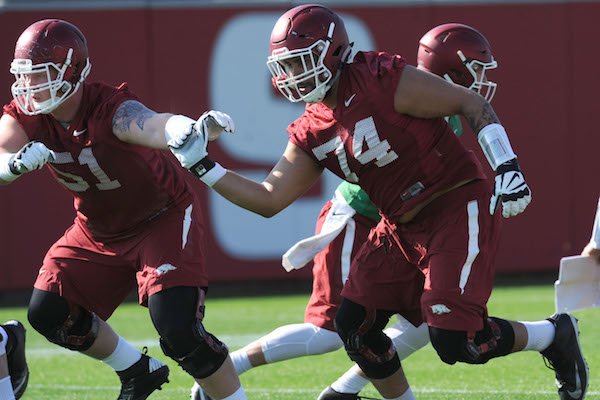 Arkansas offensive linemen Hjalte Froholdt (51) and Colton Jackson move through a drill Tuesday, March 28, 2017, during spring practice at the UA practice facility in Fayetteville. 