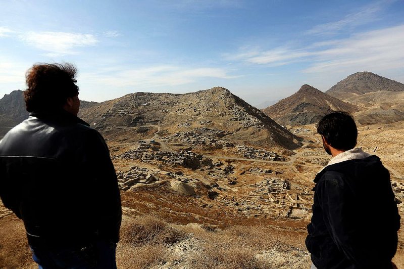 Abdul Qadir Timor, (left) director of archaeology at Afghanistan’s Ministry of Information and Culture, looks out over the mineral-rich Mes Aynak Valley, about 25 miles southwest of Kabul, in 2015.