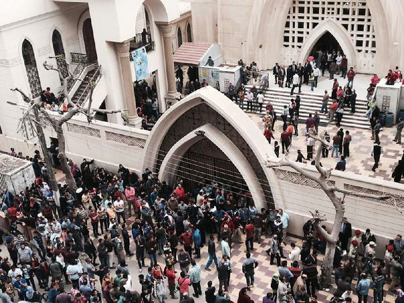 Onlookers and victims’ relatives gather outside a church after a fatal bomb attack Sunday in the Nile Delta town of Tanta, Egypt.