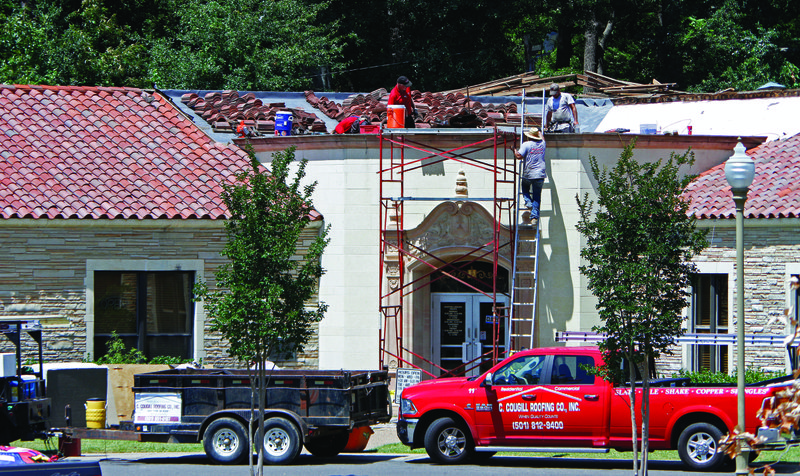 Roof Repair: Roofers with C. Cougill Roofing Company Inc. replace the Mediterranean tiles atop the entrance to the Barton Library on July 6, 2016. 