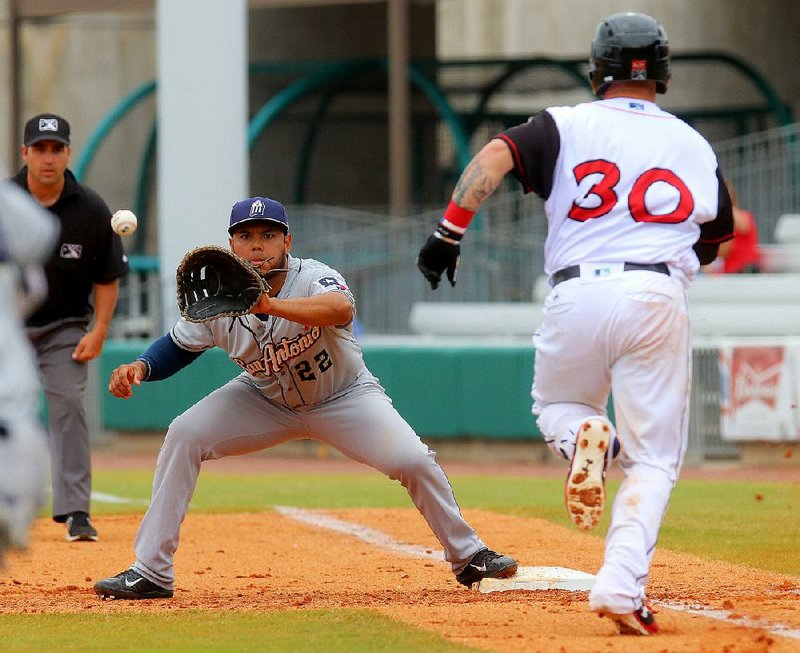 Arkansas Travelers base runner Tyler Marlene (30) is forced out at first base by Fernando Perez of the San Antonio Missions during the first game of Tuesday’s doubleheader at Dickey-Stephens Park in North Little Rock.