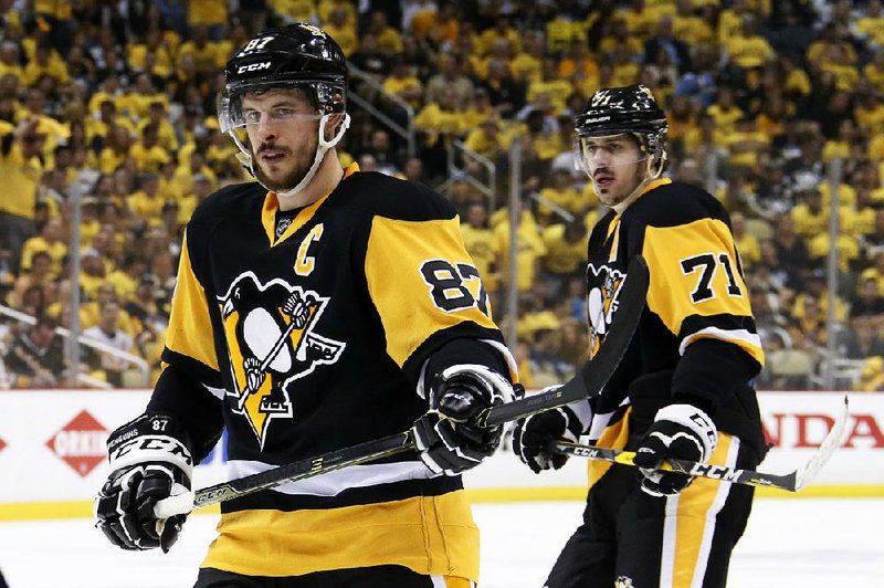 Pittsburgh Penguins' Sidney Crosby (87) and Evgeni Malkin (71) prepare for a face-off during the second period of Game 7 of the NHL hockey Stanley Cup Eastern Conference finals Thursday, May 26, 2016 in Pittsburgh. 