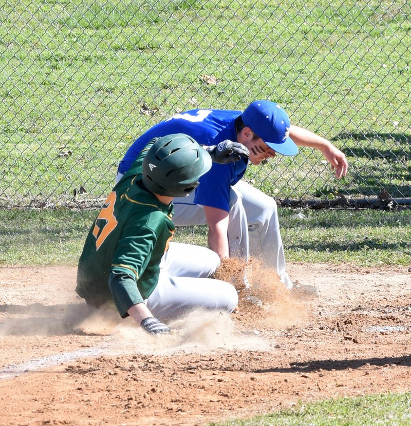 Photo by Mike Eckels Bulldog pitcher Jason Porter (7, top) tags an Eagle base runner at home plate for the second out in the first inning of the Decatur-Omaha varsity baseball game at Edmiston Ball Field in Decatur April 7.