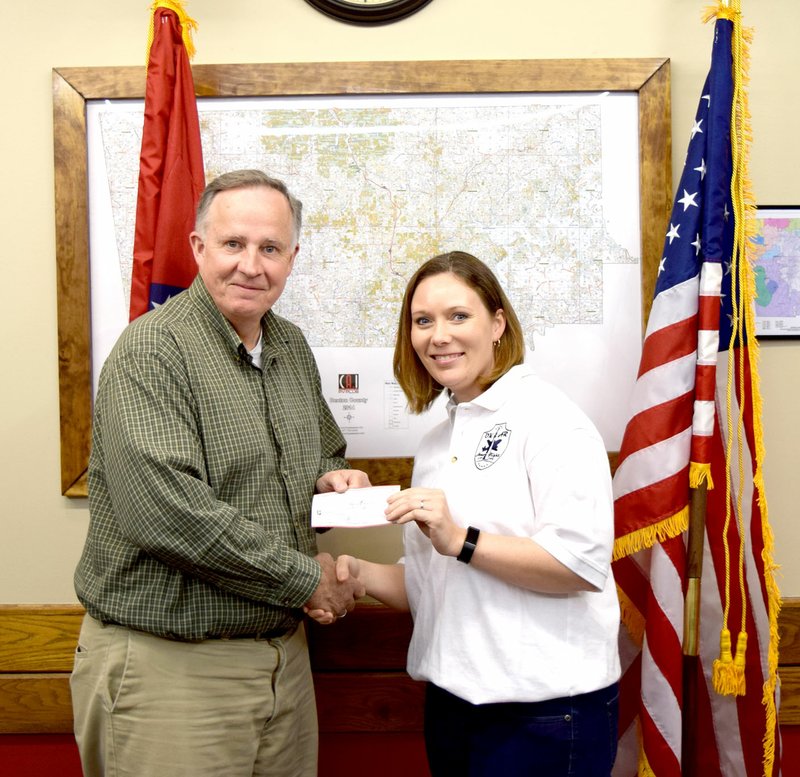 Photo by Mike Eckels Bob Bland (left), from the Fayetteville Chapter 12 Woodmen Life organization, presented a check to Jessica Duncan from the Gayland Van Dyke 5K Run committee during the Decatur Veterans Committee meeting in the committee room at Decatur City Hall March 27. The run will take place May 13 at Decatur Veterans Park.