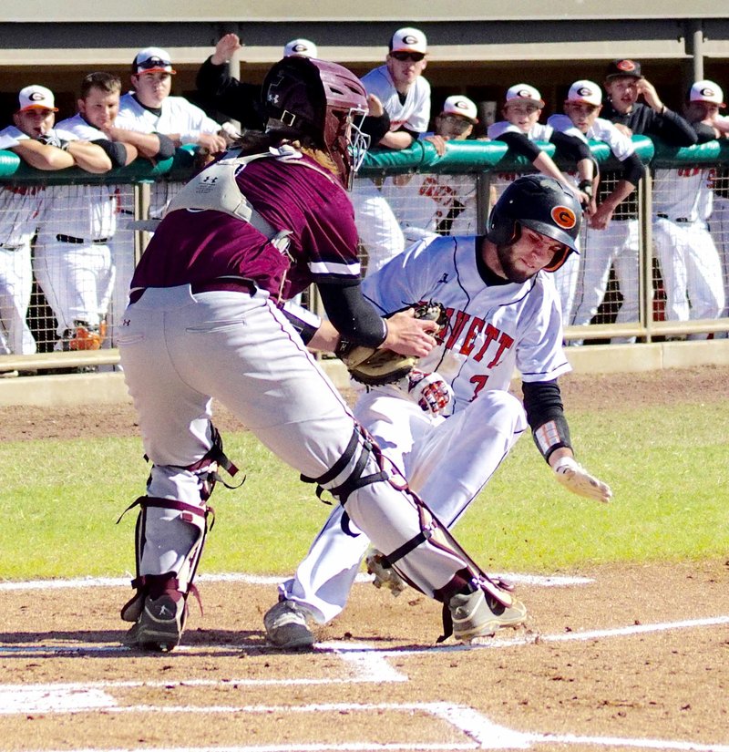 Photo by Randy Moll William Owens is tagged out as he slides into home plate during play against the Lincoln Wolves at Gravette on Thursday, April 6, 2016.