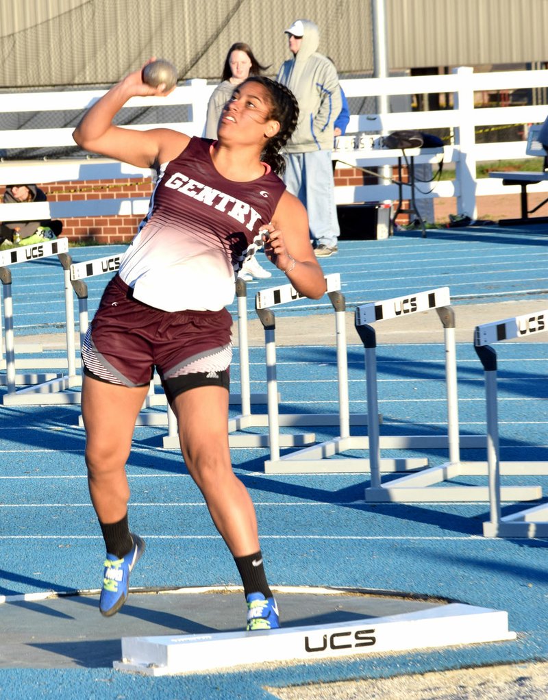 Photo by Mike Eckels Gentry&#8217;s Chastery Fuamatu gets serious energy behind her throw in the shot put during the Joe Roberts High School Relays at Har-Ber High School Track complex in Springdale April 6. Fuamatu took second place in the girls&#8217; shot put event with this throw.