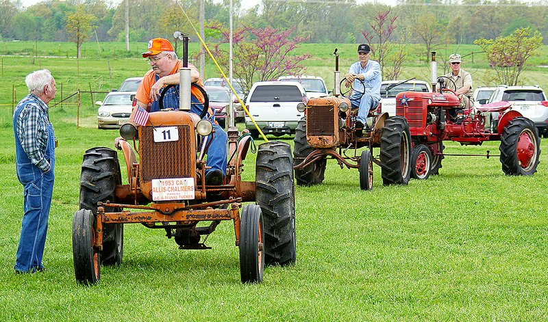 Photo by Randy Moll Antique tractors lined up for the parade of power held each noon at the Tired Iron of the Ozarks showgrounds in Gentry. The show features antiquie tractors, engines, farm machinery, a sawmill, blacksmith shop and more.