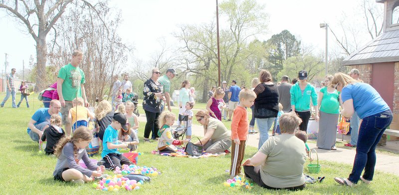 Keith Bryant/The Times of Northeast Benton County
Kids and parents sit down after Saturday's Easter egg hunt and get cracking to find out what prizes their eggs contain.