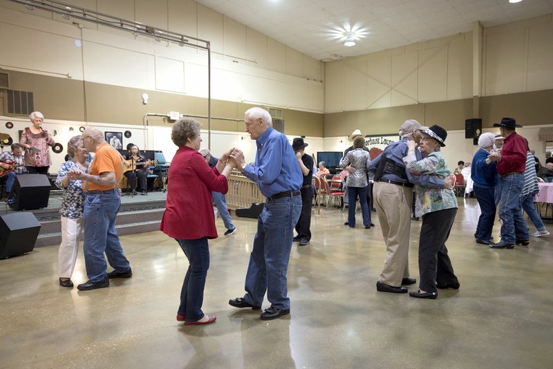 NWA Democrat Gazette/SPENCER TIREY Sue Lambert and Jim Gideon(second from left) dance along with William and Donna Green (second from right)and others during a dance and 100th birthday of Rozella Scott Thursday at the Springdale Senior Center.