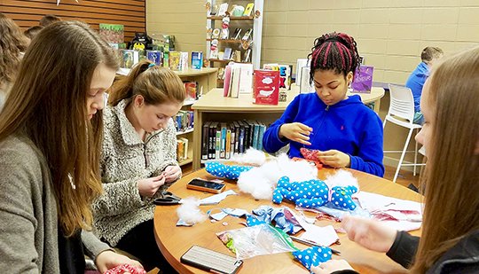 Submitted photo LAKESIDE WISDOM: Eighth-grade students, from left, Meredith McGue, Katelyn Hartsell, Dria Haywood and Gabriella Gancarczyk recently worked in the Lakeside High School library media center during their lunch period to prepare stuffed bears for children in Syria. The Wisdom House Project orphanage and school, operated by the Syrian Emergency Task Force, is located less than 30 miles from a deadly chemical weapon attack April 4.