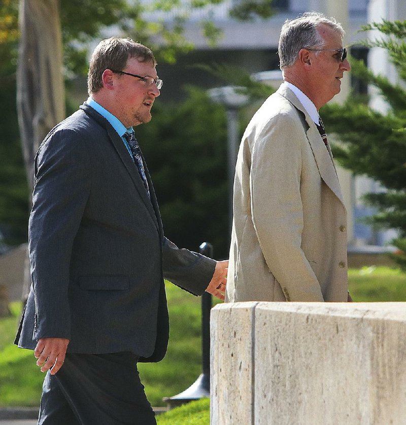 Former Little Rock police officer Josh Hastings (left) and his father, retired Little Rock police Capt. Terry Hastings, enter the federal courthouse in Little Rock on Wednesday during jury deliberations in his wrongful-death civil trial. 