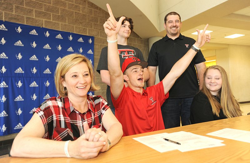 NWA Democrat-Gazette/ANDY SHUPE
Jake Benninghoff (center) celebrates Wednesday, April 12, 2017, alongside his mother, Kim (from left); brother, Drew; father, Joel; and sister, Kate; after signing to jump for the Texas Tech track and field team during a signing ceremony at Rogers High School. Visit nwadg.com/photos to see more photographs from the ceremony.