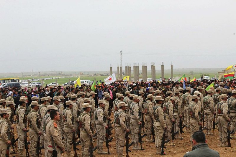 Fighters from the Syrian Democratic Forces attend a funeral procession held Thursday in Tal al-Abyad, Syria, for comradeswho were killed this week.