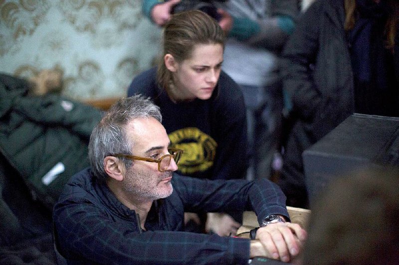 Director Olivier Assayas and star Kristen Stewart watch the playback of a scene on the set of their latest movie Personal Shopper.