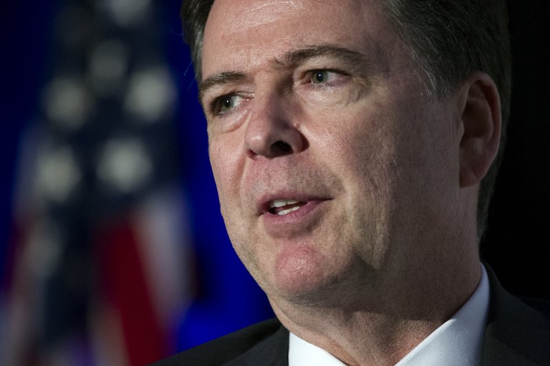 FILE - In this March 29, 2017, file photo FBI Director James Comey speaks during the Intelligence and National Security Alliance Leadership Dinner in Alexandria, Va. Comey says Americans should be mindful of foreign efforts to undermine confidence in U.S. elections. (AP Photo/Cliff Owen, File)