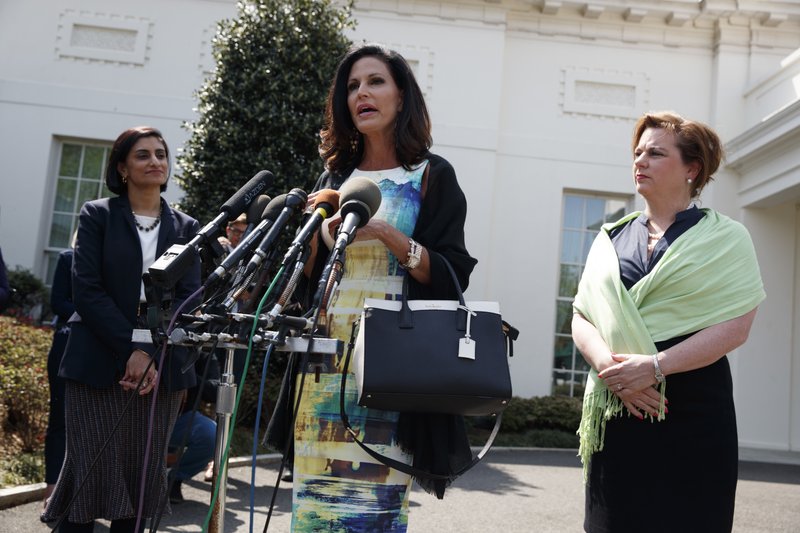 Marjorie Dannenfelser, president of the Susan B. Anthony List, right, and Seema Verma, administrator of the Centers for Medicare and Medicaid Services, left, listen as Penny Nance, CEO of Concerned Women for America, speaks with reporters outside the White House in Washington, Thursday, April 13, 2017, after President Donald Trump signed signed H.J. Res. 43, which allows states to withhold federal funds from facilities that provide abortion services. (AP Photo/Evan Vucci)