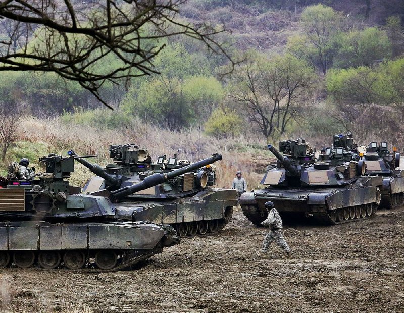 U.S. Army tanks maneuver Friday near South Korea’s border with North Korea as part of large-scale military exercises with South Korean forces, drills that have angered China and North Korea.  