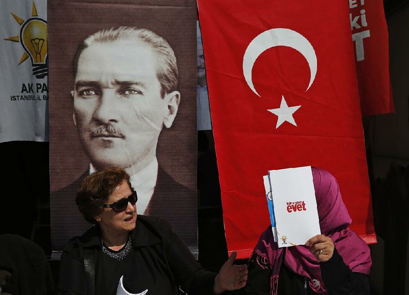 Supporters of the referendum to change Turkey’s government campaign Friday in Istanbul with a poster of modern Turkey’s founder, Mustafa Kemal Ataturk.