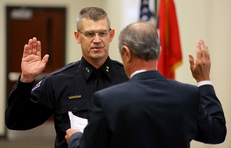 Geoffrey Herweg is sworn in as Jacksonville’s new police chief by Mayor Gary Fletcher on Friday.
