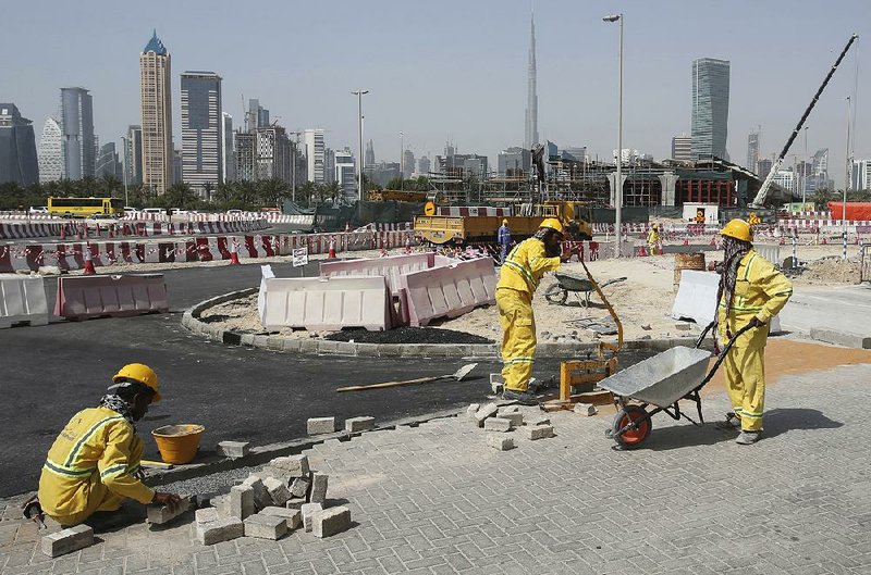 A few laborers work on a road construction site in Dubai, United Arab Emirates, last week. 