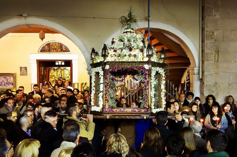 In Nafplio, Greece, a symbolic Easter casket is carried in a funeral procession that winds through town.
