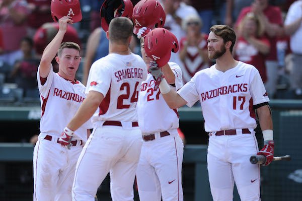 Arkansas first baseman Chad Spanberger (24) is congratulated at the plate by shortstop Jax Biggers (from left), designated hitter Evan Lee and left fielder Luke Bonfield against Georgia Saturday, April 15, 2017, after hitting a three-run home run during the second inning at Baum Stadium in Fayetteville.