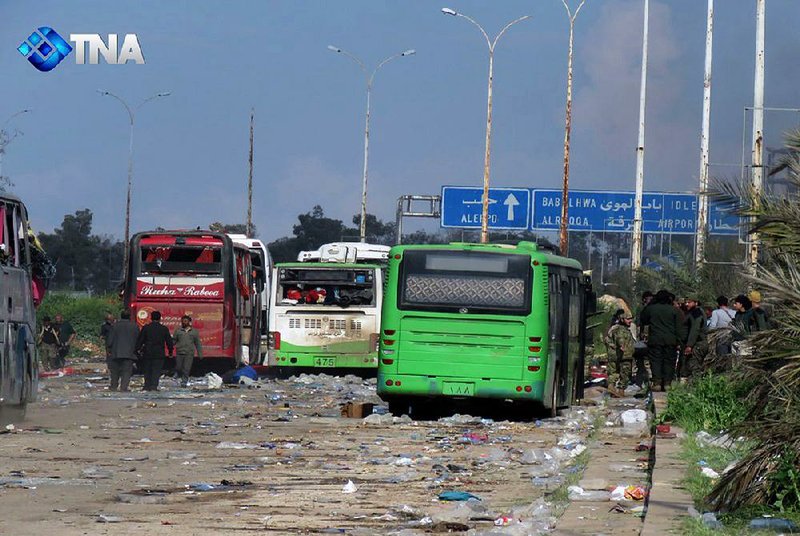 Damaged buses sit at an evacuation point Saturday outside Aleppo, Syria, in this image taken from video, after an explosion killed at least 100 people.