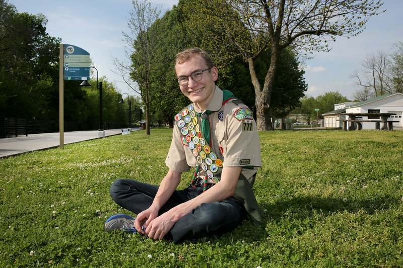 Hogan Maestri, 17, sits Friday at the location of his proposed Fallen Soldier Memorial at Shiloh Memorial Park in Springdale. Hogan is raising money to have a memorial at the park. The bronze monument will honor those from Springdale who died in battle while serving the military for the United States. The project is his Eagle Scout service project. He hopes to raise $15,000, the cost of the monument, before his 18th birthday July 28.