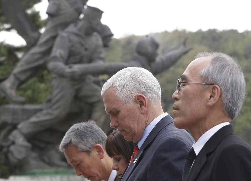U.S. Vice President Mike Pence, second from right, and his wife Karen pay a silent tribute at the National Cemetery in Seoul, South Korea, Sunday, April. 16, 2017. 
