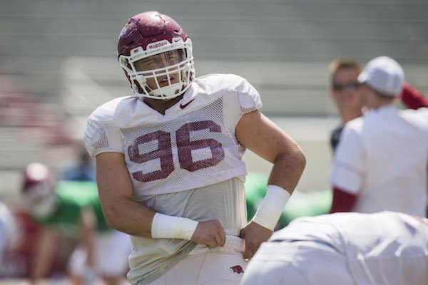 Arkansas defensive end Karl Roesler stretches before the Razorbacks' scrimmage Saturday, April 15, 2017.