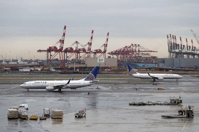 United Airlines jets are shown last week at Newark Liberty International Airport in Newark, N.J. The airline on Monday reported a $96 million first-quarter profit, a sharp drop from a year ago.
