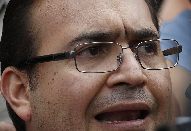 In this Aug. 5, 2016, file photo, the former Governor of Veracruz state, Javier Duarte speaks to reporters as he leaves the Attorney General's headquarters in Mexico City. 