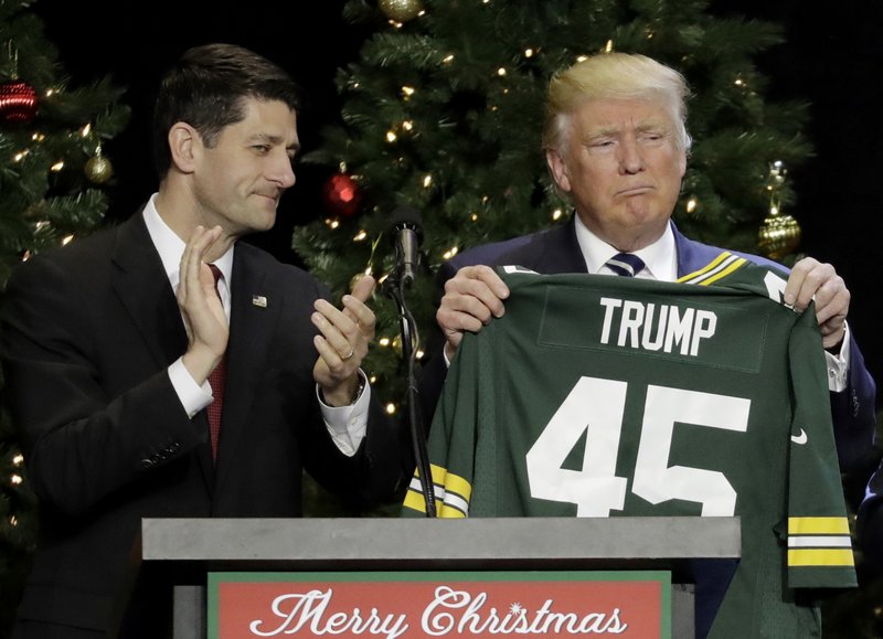 In this Dec. 13, 2016, file photo, President-elect Donald Trump holds up Green Bay Packers jersey given to him by House Speaker Paul Ryan at a rally in West Allis, Wis. 