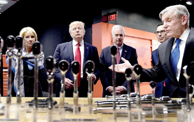 President Donald Trump tours the Kenosha, Wis., headquarters of tool manufacturer Snap-on Inc. on Tuesday with Chief Executive Officer Nicholas T. Pinchuk (right). From left are Education Secretary Betsy DeVos, Trump, Sen. Ron Johnson, R-Wis., Treasury Secretary Steven Mnuchin and Pinchuk.