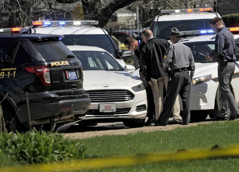 Pennsylvania State Police officials investigate Tuesday in Erie at the scene where murder suspect Steve Stephens killed himself as police officers tried to stop his vehicle. Stephens, the subject of a multistate manhunt after he killed a retired Cleveland man and posted video of it on Facebook, was recognized at a McDonald’s in Erie, and a worker called the police.