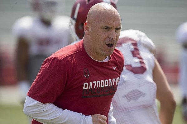 Arkansas outside linebackers coach Chad Walker goes through practice Saturday, April 8, 2017, in Fayetteville. 