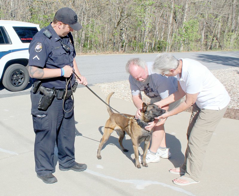 Keith Bryant/The Weekly Vista K9 officer Travis Trammel stands with a lead while Cabo meets Bill Dietman and Jan Dietman, who donated funds to better equip the department&#8217;s K9 unit.
