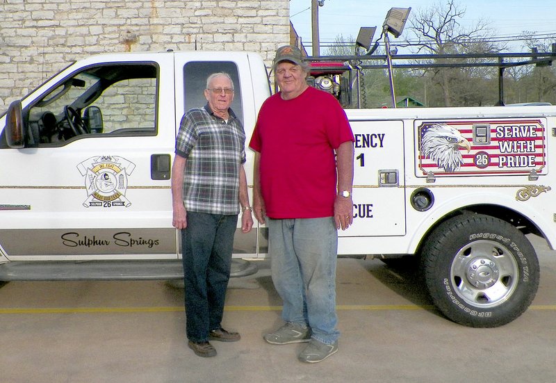 Photo by Larry Burge Sulphur Springs firefighters Arnie Hutchison and current fire chief John Varner are pictured standing in front of the town&#8217;s newly acquired first-responder truck.