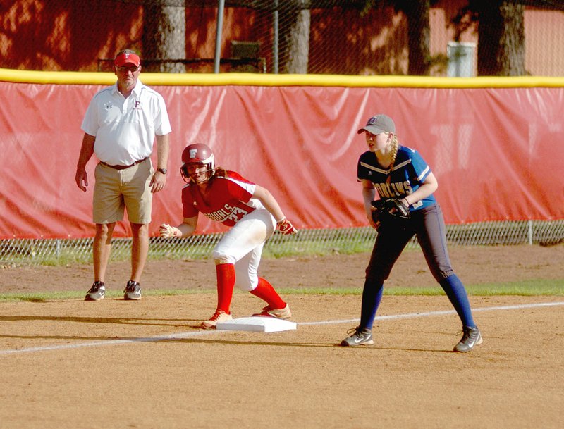 MARK HUMPHREY ENTERPRISE-LEADER Farmington coach Randy Osnes, shown coaching third base while Carley Antwine poises herself to race home against Harrison in an 8-1 victory on April 4, quietly achieved a milestone with his 500th career win April 1 over Conway. Osnes has been head coach at Farmington since 1998. He has guided the Lady Cardinals to state championships in 2000, 2005 and 2011, three state runner-up finishes in 2001, 2002 and 2003, plus 18 conference championships. As of Friday, the Lady Cardinals&#8217; 2017 record stands at 16-7.