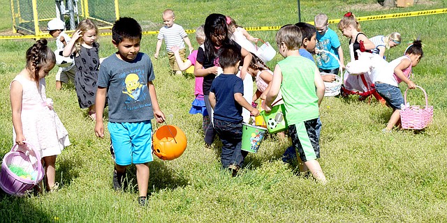 Photo by Mike Eckels A group of children scour the ground hoping to find a hidden treasure during the 2017 Decatur Chamber of Commerce Easter Egg Hunt at Veterans Park in Decatur April 15. Over 1000 plastic eggs were scattered across the park for children ages 0-12 to find.