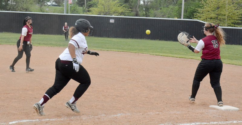 Graham Thomas/Herald-Leader Gentry second baseman Billi Taylor, left, tosses to first baseman Makensi Sweeten to throw out Siloam Springs freshman runner Rachel Mann in the semifinals of the Lady Panther Invitational on Saturday at La-Z-Boy Park.