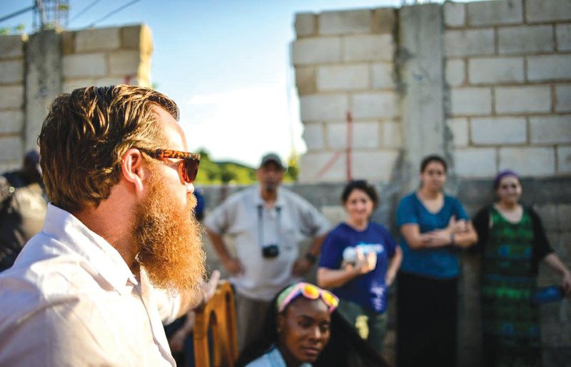 Eric Richardson, left, speaks in front of a group of pastors and youth leaders during a trip to Haiti last April. Richardson said they spend a few days there to better understand how their groups could partner with the pastors in Haiti to help meet the needs of the communities and churches.