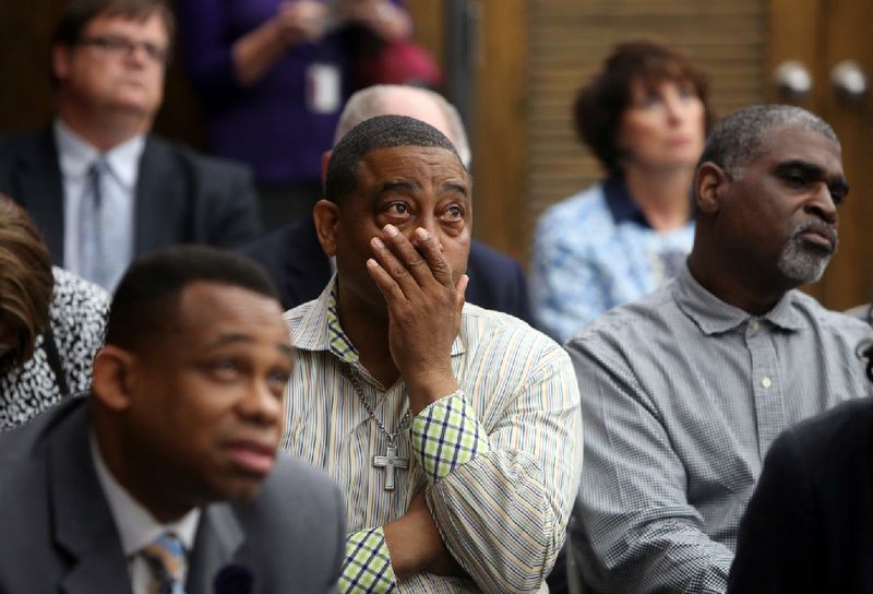 Deron Hamilton (from left), accountant for Covenant Keepers charter school; Tyron Tatum, husband of Covenant Keepers Superintendent Valerie Tatum; and Noland Buckley, president of Covenant Keepers’ board, listen Wednesday as the state Charter Authorizing Panel votes to revoke the school’s charter.