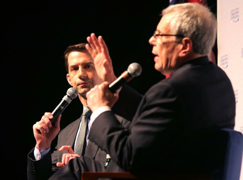Clinton School of Public Service Dean Skip Rutherford (right), quiets noises from anti-Donald Trump audience members so that U.S. Sen. Tom Cotton (left) can answer a question during an event Wednesday at the Robinson Center in Little Rock.