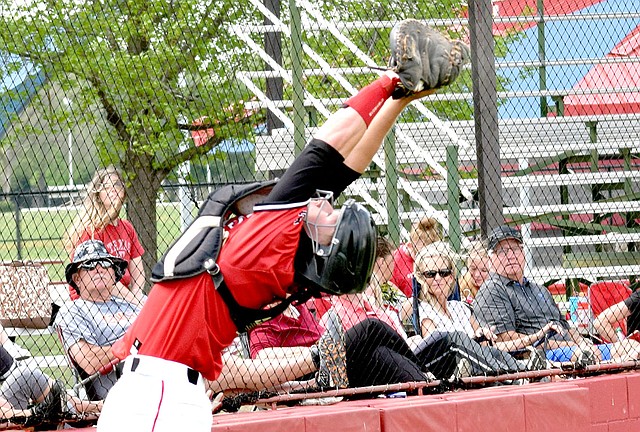 Photo by Rick Peck McDonald County catcher Emmanuel Baisch reaches back to catch a foul pop-up during the Mustangs&#8217; 10-8 loss to Providence Academy on April 15 at Grove High School.