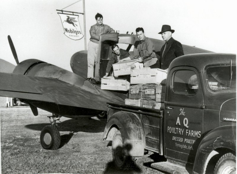 Photo courtesy of the Rogers Historical Museum C. Jimmy Carter (right, with hat) flies the first weekly shipment of broilers from the Rogers airport, Nov. 30, 1949. The pilot proclaimed the bean-field airstrip as one of the worst in the world. Carter built a suitable airstrip, then led to the extension and lighting of the runways and construction of facilities for the storage and sale of airplane fuel. The airfield at Rogers Municipal Airport is named in his honor.