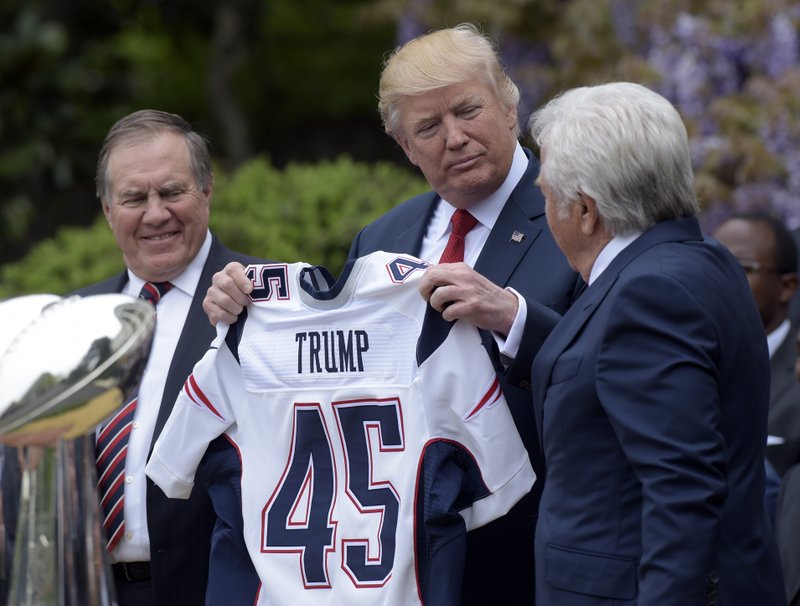 President Donald Trump is presented a New England Patriots jersey by Patriots owner Robert Kraft, right, and head coach Bill Belichick during a ceremony on the South Lawn of the White House in Washington, Wednesday, April 19, 2017, where the president honored the Super Bowl Champion New England Patriots for their Super Bowl LI victory. 