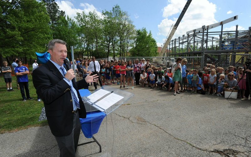 NWA Democrat-Gazette/ANDY SHUPE Dennis Chapman, president and head of The New School, speaks Wednesday during a beam-raising and tour of the school's expansion in Fayetteville. The school hopes to open the facility in the fall for the 2017-18 school year.